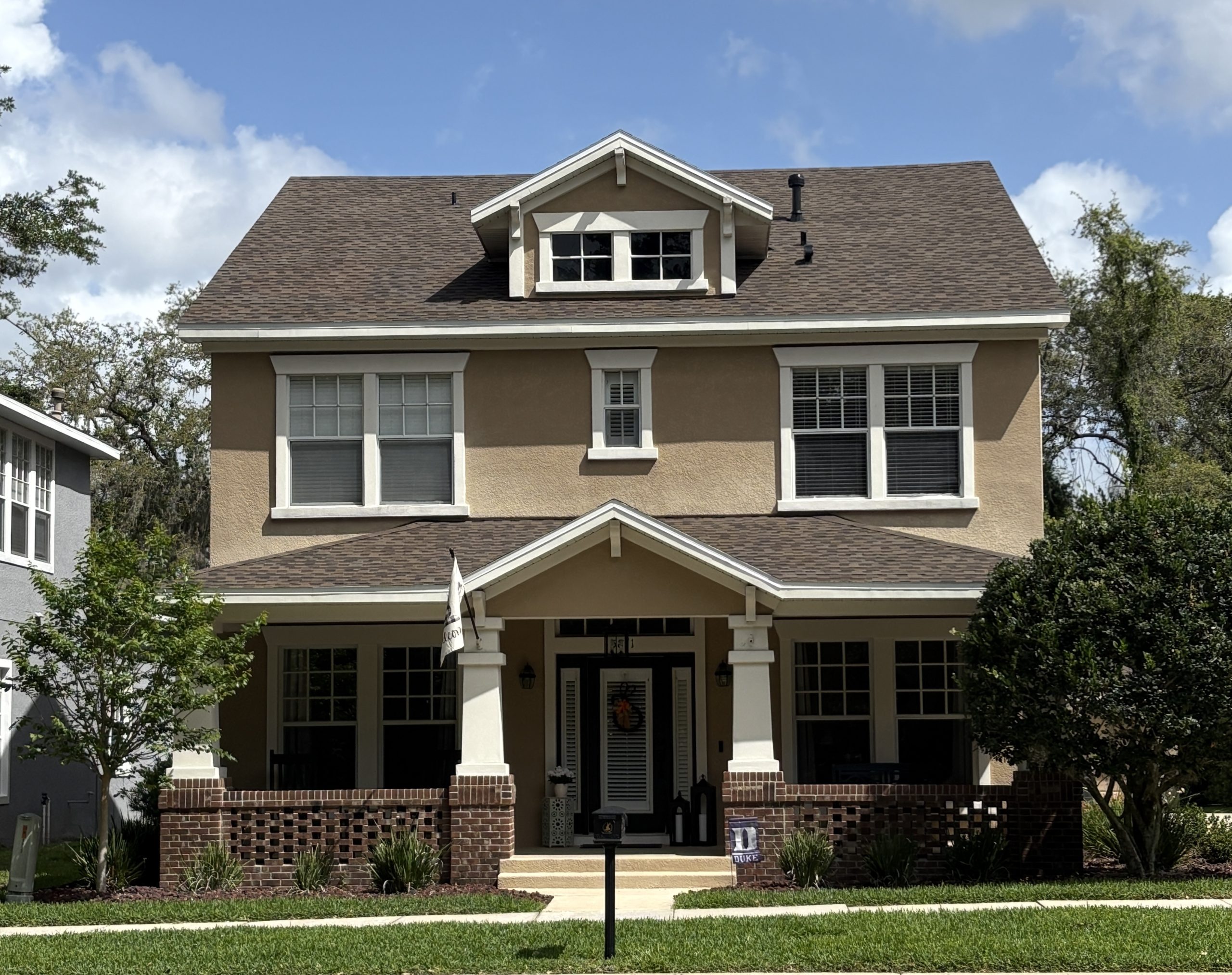 Craftsman-style home in FishHawk Ranch Garden District, Lithia FL — showcasing front porch charm, tree-lined streets, and walkable community living.