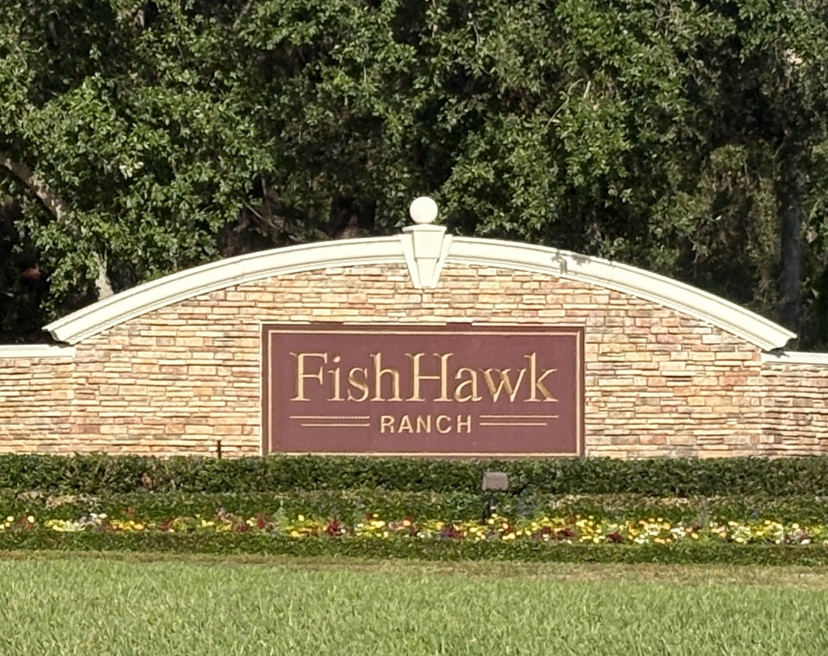 Entrance sign for FishHawk Ranch in Lithia FL, welcoming residents and visitors to the Garden District community known for its amenities, walkability, and vibrant landscaping.