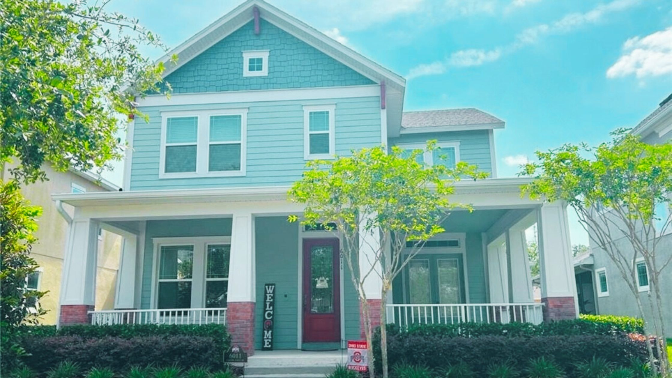 Charming two-story craftsman-style home with wraparound porch in Fishhawk Ranch, FL — a popular family-friendly community known for top-rated schools, scenic trails, and vibrant curb appeal.